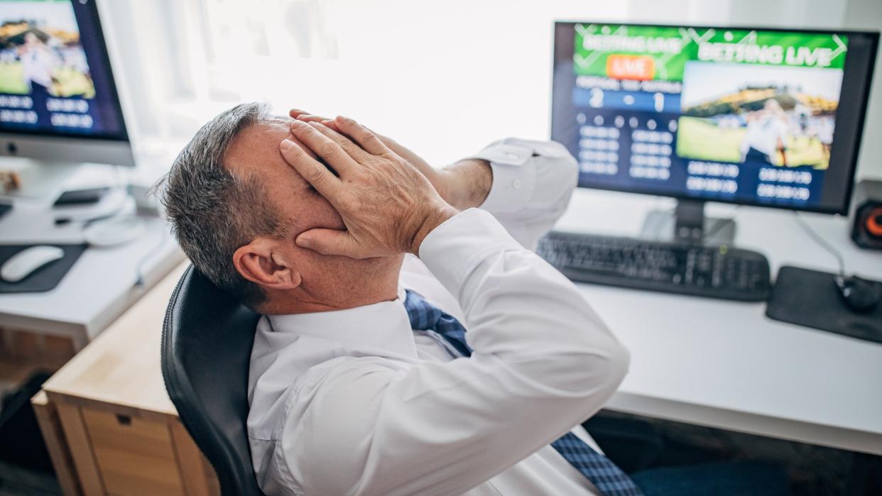 One senior business man live betting at his home office and lose game.