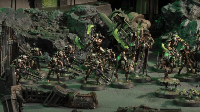 An army of metallic Necron miniatures on the move across a desolate, ruined landscape