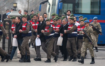 Turkish soldiers accused of attempting to assassinate President Tayyip Erdogan on the night of the failed last year's July 15 coup, are escorted by gendarmes as they arrive for the first hearing of the trial in Mugla, Turkey, February 20, 2017. REUTERS/Kenan Gurbuz