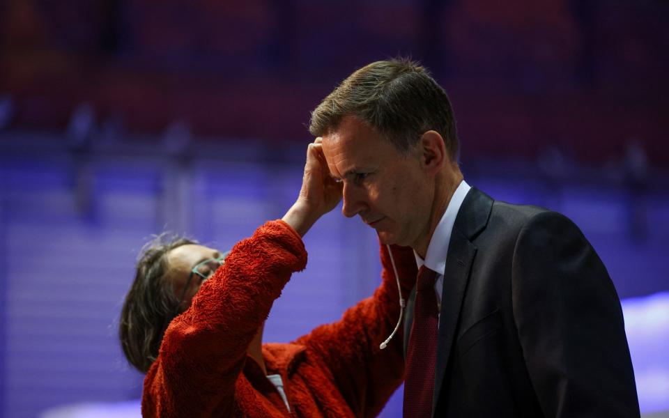 Jeremy Hunt, the Chancellor, prepares for a TV interview in Manchester this morning