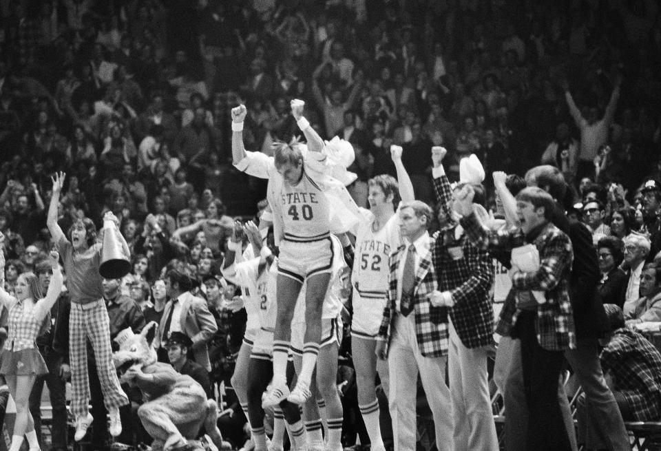 FILE - In this March 23, 1974, file photo, North Carolina State's Mark Noeller (40) jumps into the air as they defeat UCLA 80-77 in double overtime in a semifinal game at the NCAA college basketball championships in Greensboro, N.C. (AP Photo/File)