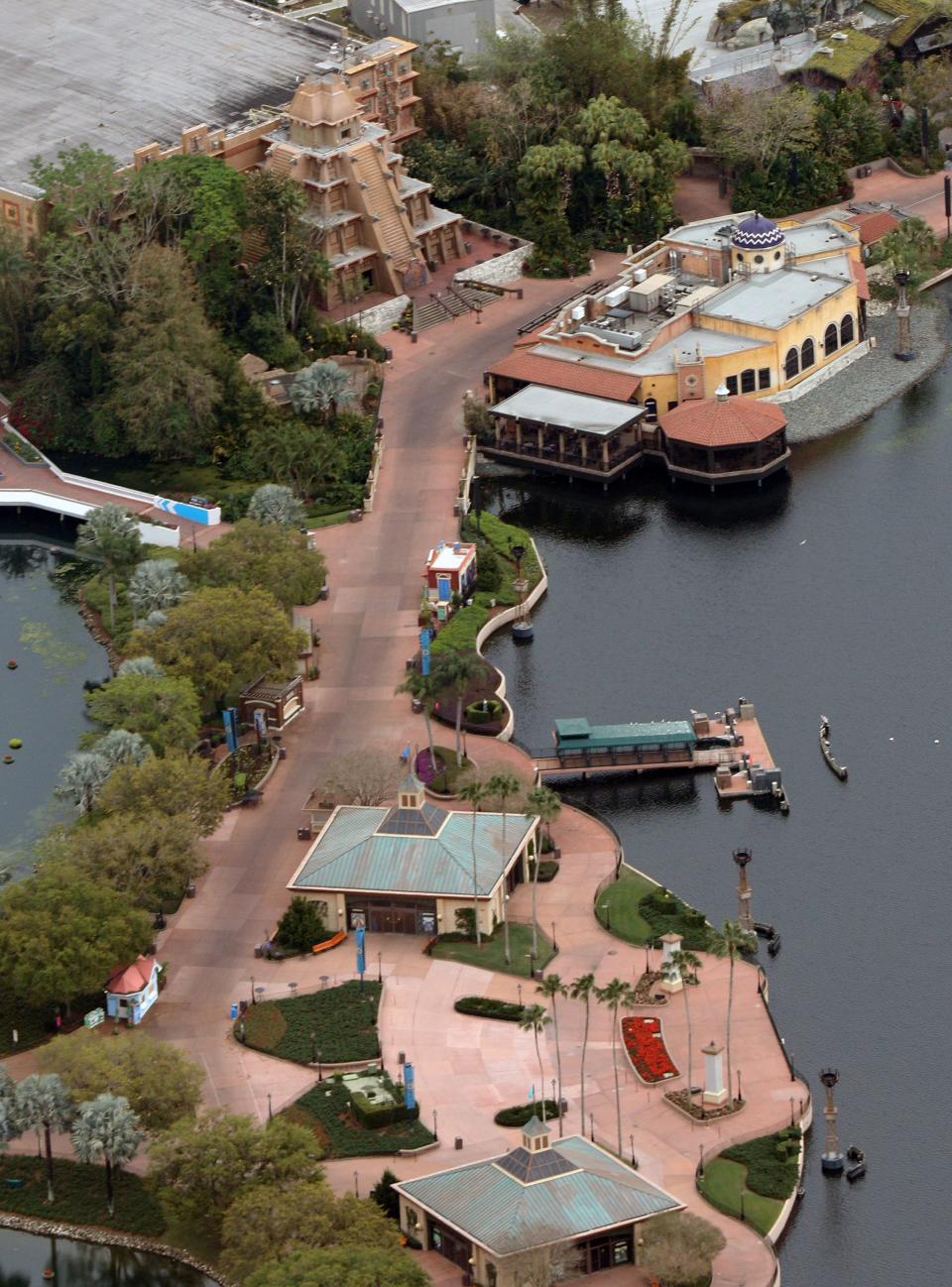 Empty streets are seen near a Mesoamerican pyramid (top left) and the Cantina de San Angel (right) at the Mexico Pavilion at Disney's Epcot theme park after it was closed to visitors in an effort to combat the spread of coronavirus disease (COVID-19), in an aerial view in Orlando, Florida, U.S. March 15, 2020.   REUTERS/Gregg Newton