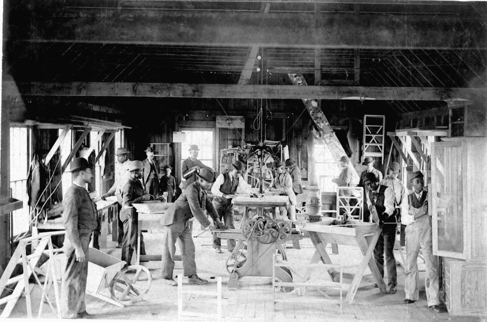 Students work in a machine shop at the Delaware State College for Colored Students in Dover, now Delaware State University, in this photo from about 1900.