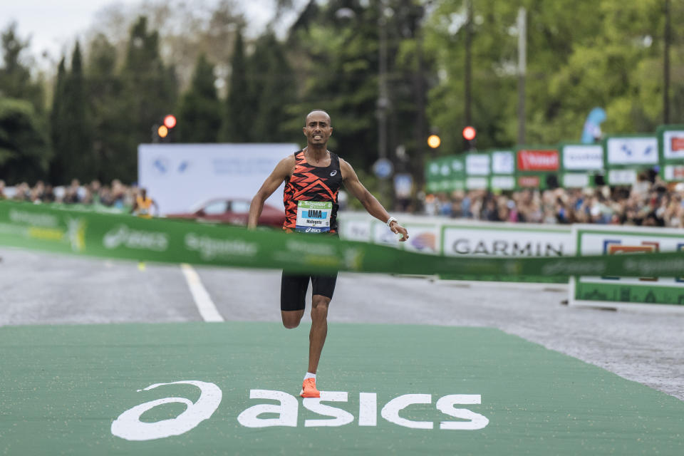 Uma Mulugeta of Ethiopia crosses the finish line to win the men's race of the Paris marathon, in Paris, Sunday, April 7, 2024. (AP Photo/Lewis Joly)