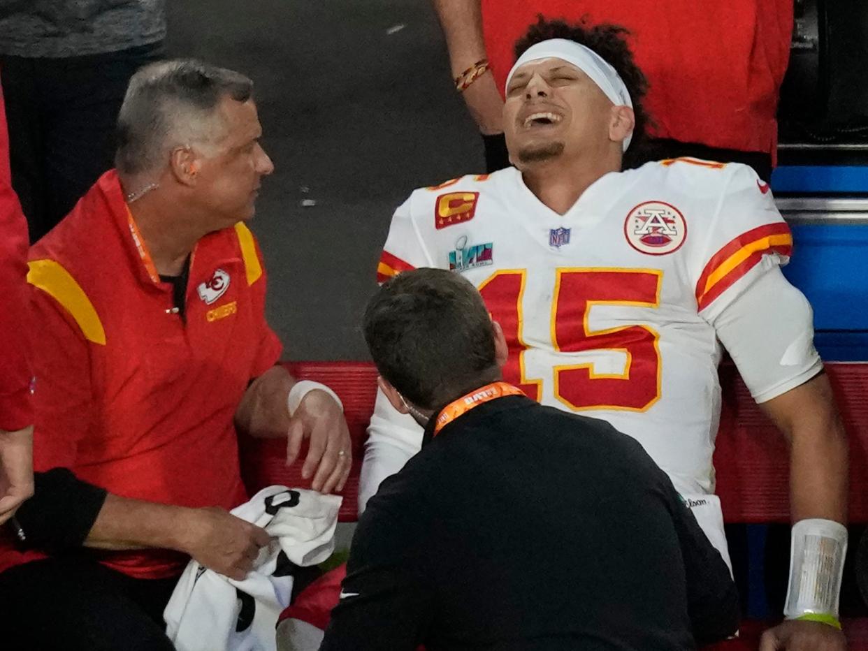 Patrick Mahomes sits on the sidelines after injuring his ankle during the Super Bowl