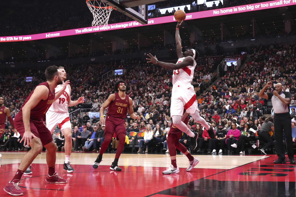 Toronto Raptors' Pascal Siakam shoots as Cleveland Cavaliers guard Max Strus, Raptors center Jakob Poeltl (19) and Cavaliers centre Jarrett Allen look on during the first half of an NBA basketball game in Toronto, Monday, Jan. 1, 2024. (Chris Young/The Canadian Press via AP)