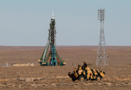 Security personnel drive an armored vehicle past the Soyuz MS-10 spacecraft with the crew of astronaut Nick Hague of the U.S. and cosmonaut Alexey Ovchinin of Russia, shortly before its launch to the International Space Station (ISS) from the launchpad at the Baikonur Cosmodrome, Kazakhstan October 11, 2018. REUTERS/Shamil Zhumatov