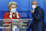 European Council President Charles Michel, right, and European Commission President Ursula von der Leyen put on their protective face mask at the end of a media conference after an EU summit in video conference format at the European Council building in Brussels, Thursday, Oct. 29, 2020. EU leaders held a video conference to address the need to strengthen the collective effort to fight the COVID-19 pandemic. (Olivier Hoslet, Pool via AP)