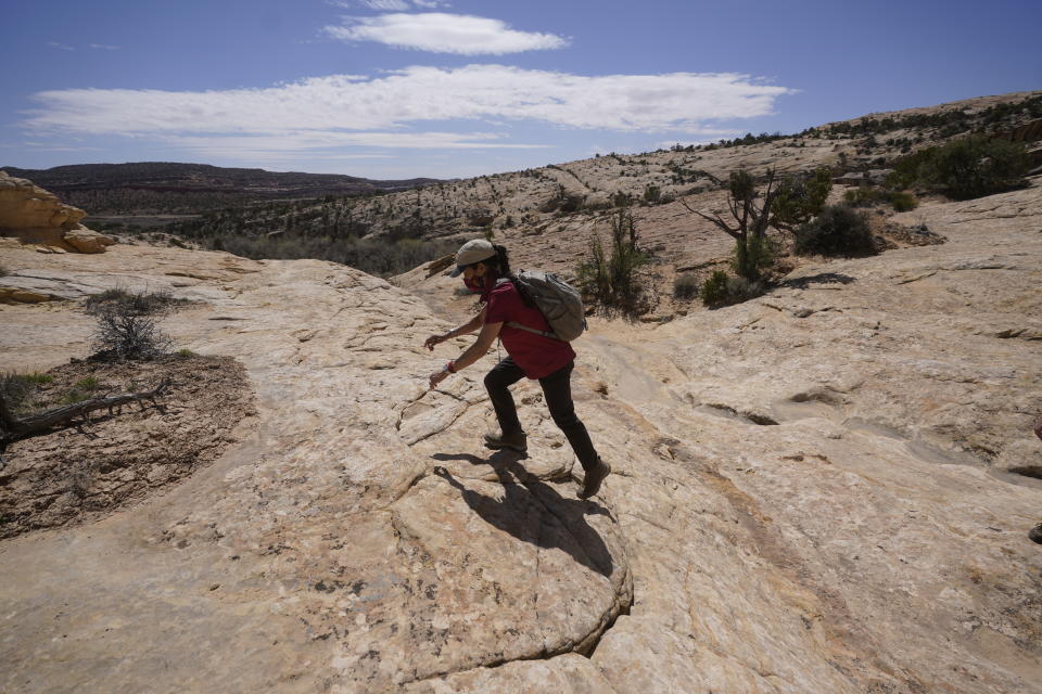 U.S. Interior Secretary Deb Haaland tours near ancient dwellings along the Butler Wash trail during a visit to Bears Ears National Monument Thursday, April 8, 2021, near Blanding, Utah. (AP Photo/Rick Bowmer, Pool)