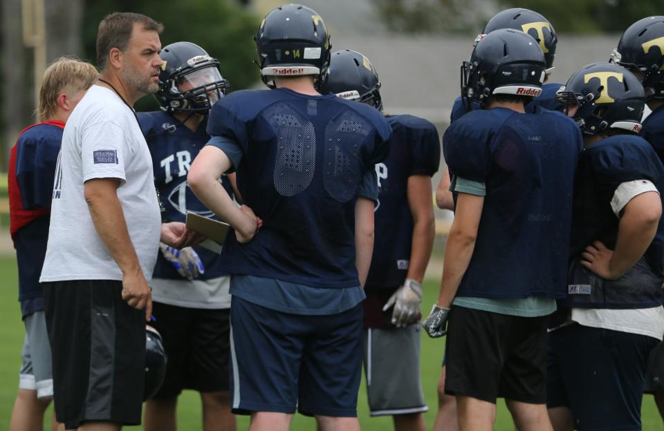 Traip Academy head coach Eric Lane working with the first team offense during practice in Kittery Wednesday, Aug. 16, 2023