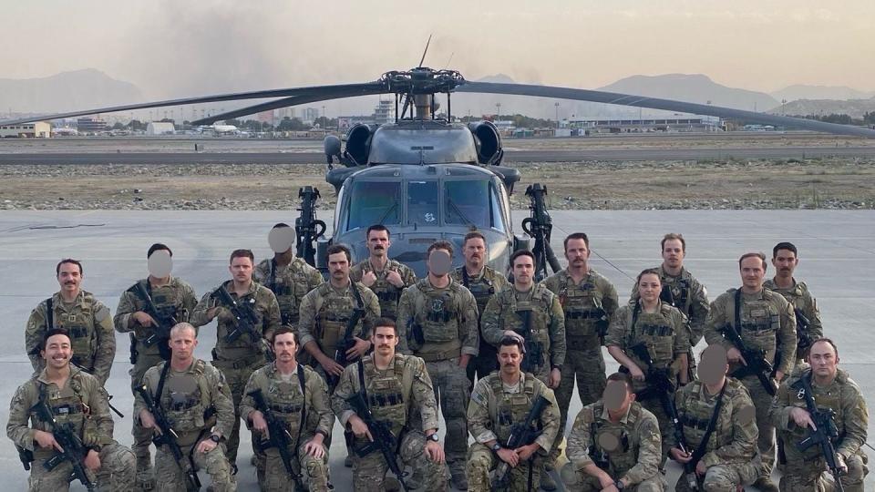 Aircrew and support personnel from the 66th Rescue Squadron pose in front of an HH-60G Pave Hawk while deployed to Hamid Karzai International Airport, Kabul, Afghanistan, Aug. 24, 2021. The Air Force has modified this photo for operational security. (Photo courtesy of Maj. Mark Ross)