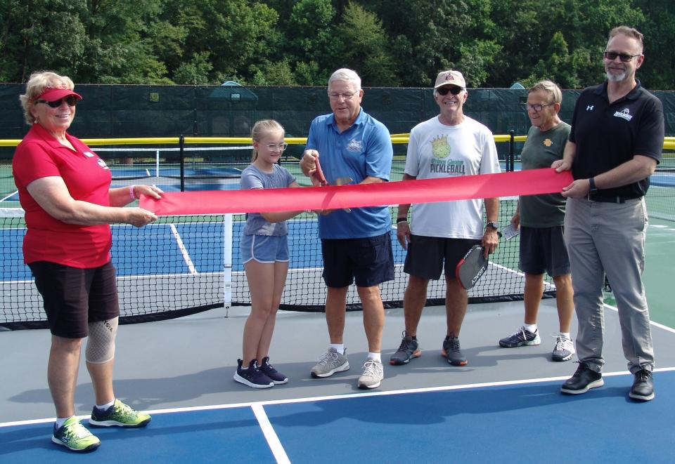 From left to right, Linda Scott, Virginia Central District USA Pickleball Ambassador, Elizabeth "Lizzy" Peters, Donald Hunter, Chairman Prince George County Board of Supervisors, Jared Dieffenbach, Prince George County Pickleball Ambassador/USA Pickleball Ambassador, Larry Heidorn, Prince George Parks and Recreation Commission member and Keith Rotzoll, Prince George Parks and Recreation Director celebrate new pickleball courts at Temple Recreation Park with a ribbon-cutting ceremony in Prince George County on July 19, 2023.