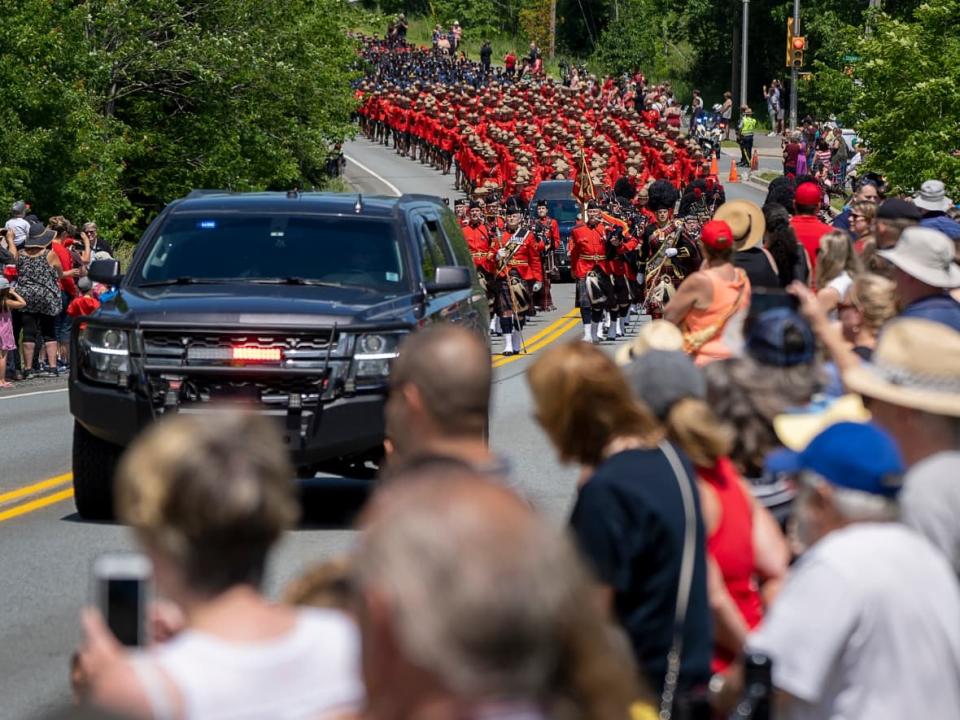 RCMP members escort the hearse at a regimental memorial service for Const. Heidi Stevenson, killed in the line of duty during the 2020 mass shooting in Nova Scotia.  (Andrew Vaughan/The Canadian Press - image credit)