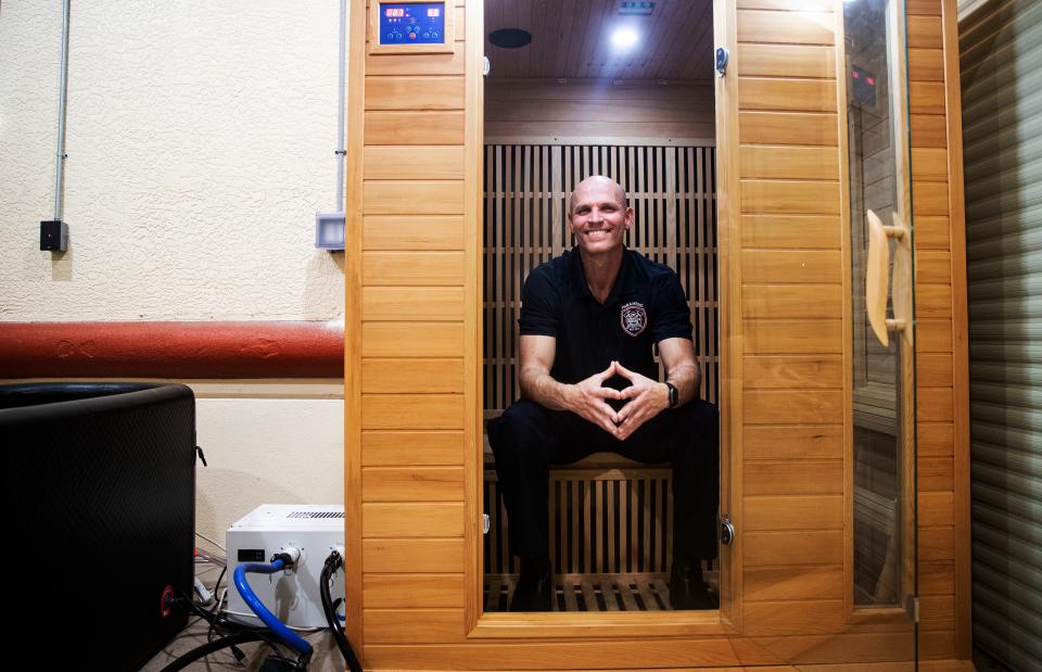 David Perez, an Engineer/Paramedic for the North Collier Fire Department sits for portrait in a sauna at the headquarters in Naples on Tuesday, March 12, 2024. Since 2020, Perez has been diagnosed with two forms of cancer, multiple myeloma and mantle cell lymphoma. The diagnoses are on the list cancers that are associated with being a firefighter according a bill that Gov. Ron DeSantis signed into law in 2019. He became in cancer free in Sept. 2023. He attributes his recovery with a healthy mindset, a strict exercise regime, a healthy diet and the use of a sauna along with traditional cancer treatments. He is currently not actively fighting fires, but is educating colleagues on cancer safety.