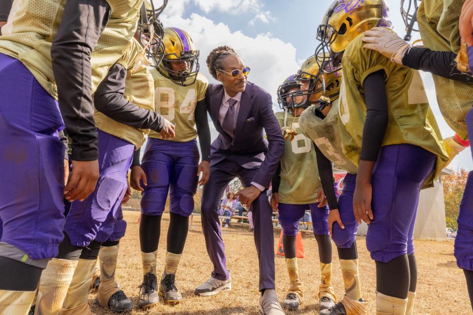 Snoop Dogg (center) stars as a self-centered former pro who reluctantly takes on coaching duties for a kids' football team in the sports comedy "The Underdoggs."