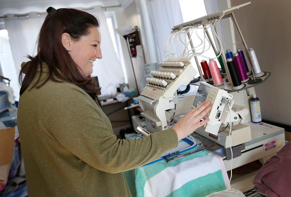 Allyson Yorks, of Click + Stitch Embroidery in Quincy, loads a design into her stitching machine on Wednesday, Jan. 26, 2022.