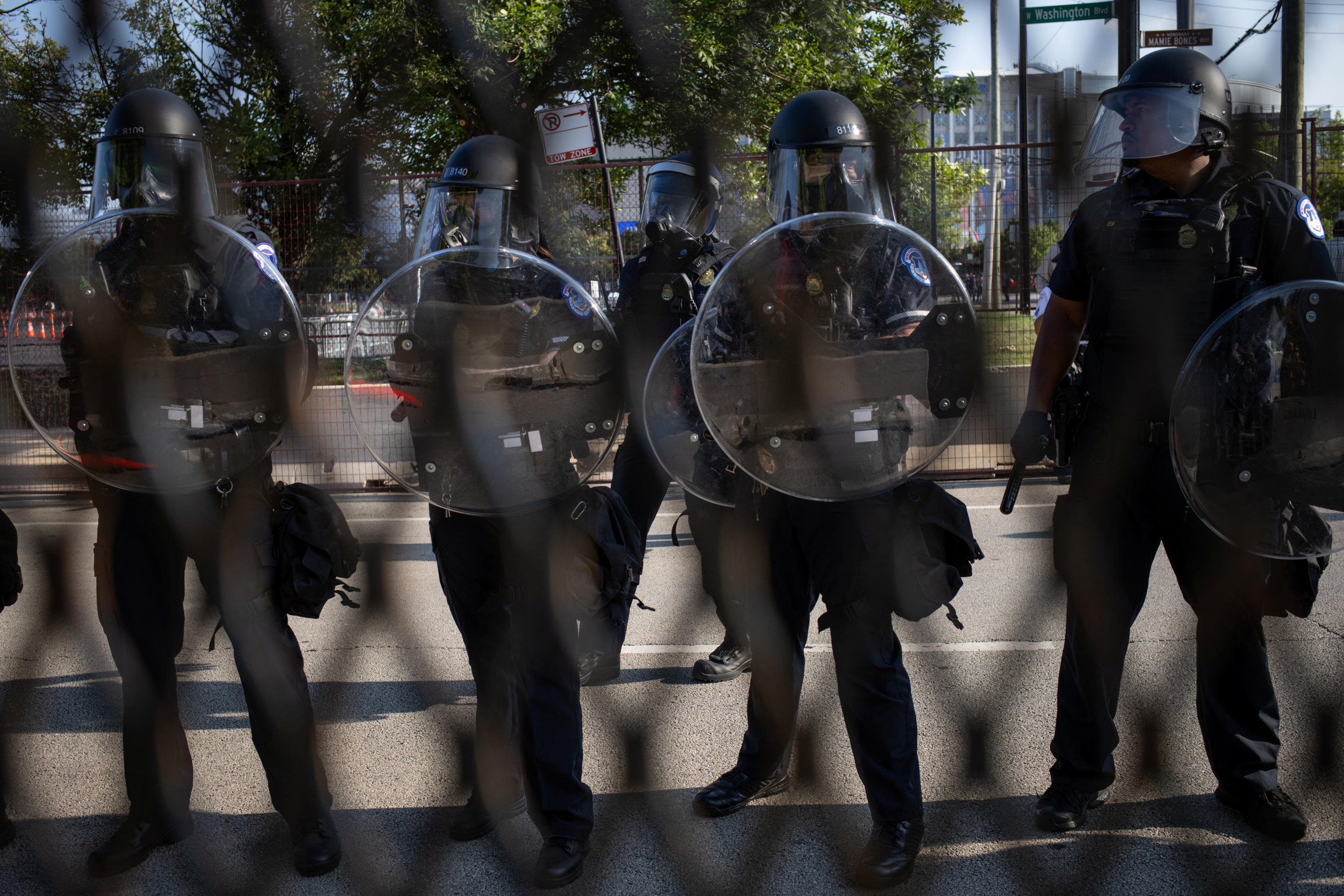 Police in riot gear monitor a demonstration and guard the grounds of the Democratic National Convention in Chicago on Monday. (Adrees Latif/Reuters)