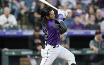 Colorado Rockies' Connor Joe loses his batting helmet while swinging at a pitch from San Francisco Giants starting pitcher Alex Cobb in the third inning of a baseball game Tuesday, May 17, 2022, in Denver. (AP Photo/David Zalubowski)