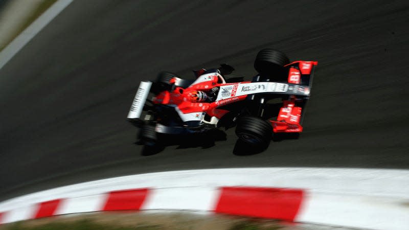 A photo of the Midland F1 car racing in Italy. 