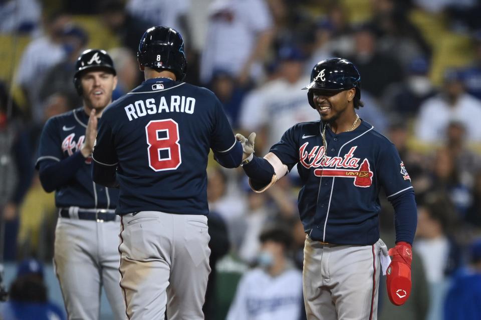 Eddie Rosario celebrates with teammates after his home run in the ninth inning of Game 4.