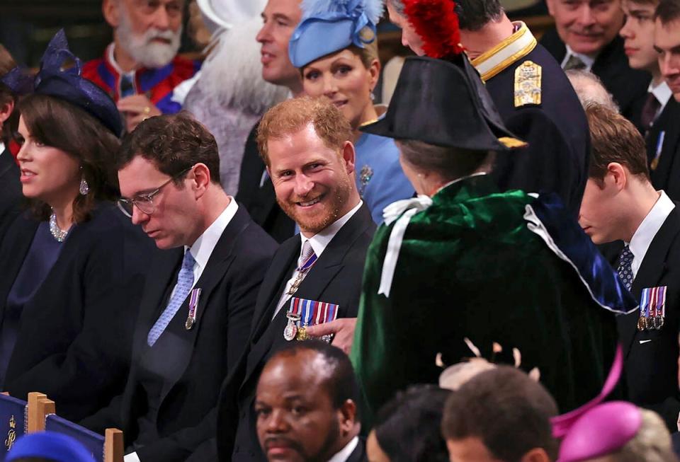 Prince Harry, center, speaks with Anne, the Princess Royal in Westminster Abbey, ahead of the coronation of King Charles III and Camilla, the Queen Consort. (AP)