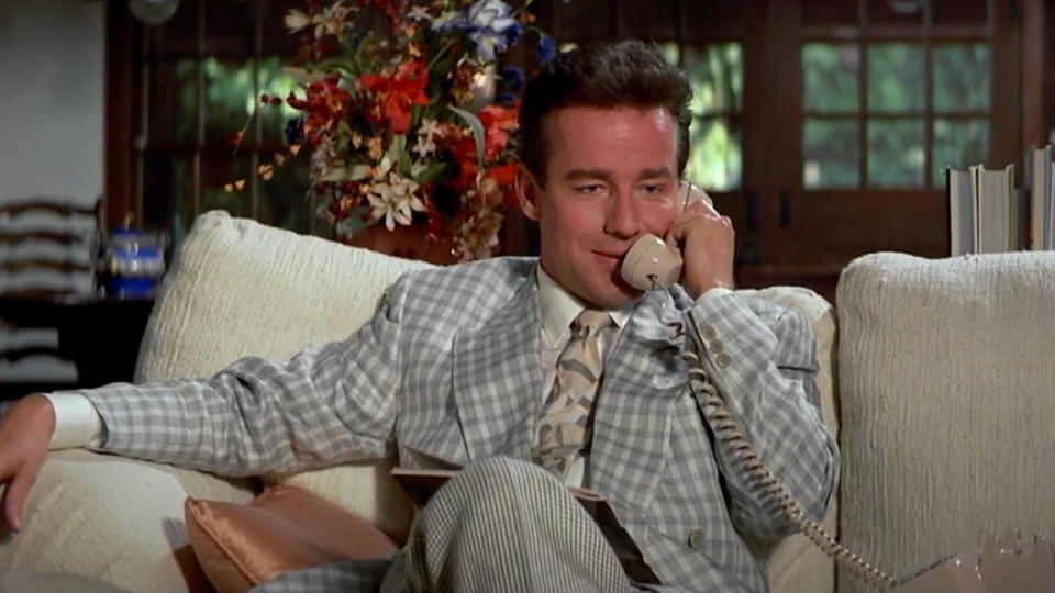 Phil Hartman sits on the phone looking amused in Blind Side.