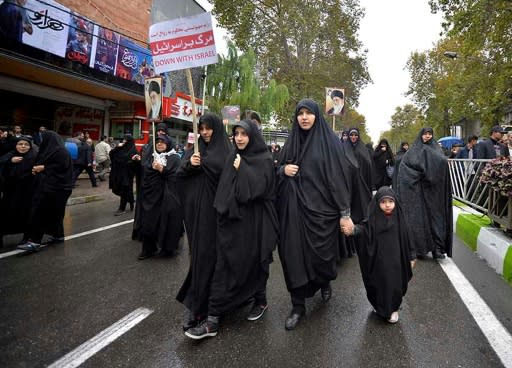 Iranian government supporters rally following the protests in with petrol pumps were torched, police stations attacked and shops looted