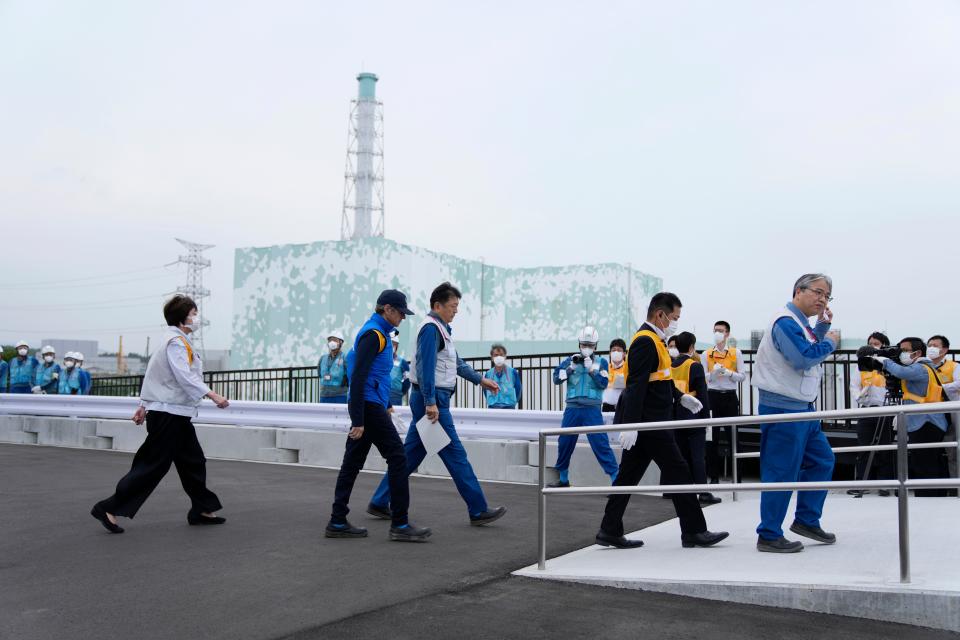 Rafael Mariano Grossi, Director General of the International Atomic Energy Agency, second left, arrives to inspect the damaged Fukushima nuclear power plant as Tomoaki Kobayakawa, President of Tokyo Electric Power Co., third left, escorts him in Futaba, northeastern Japan, Wednesday, July 5, 2023. Japan's Vice Industry Minister Fusae Ota, left, follows.