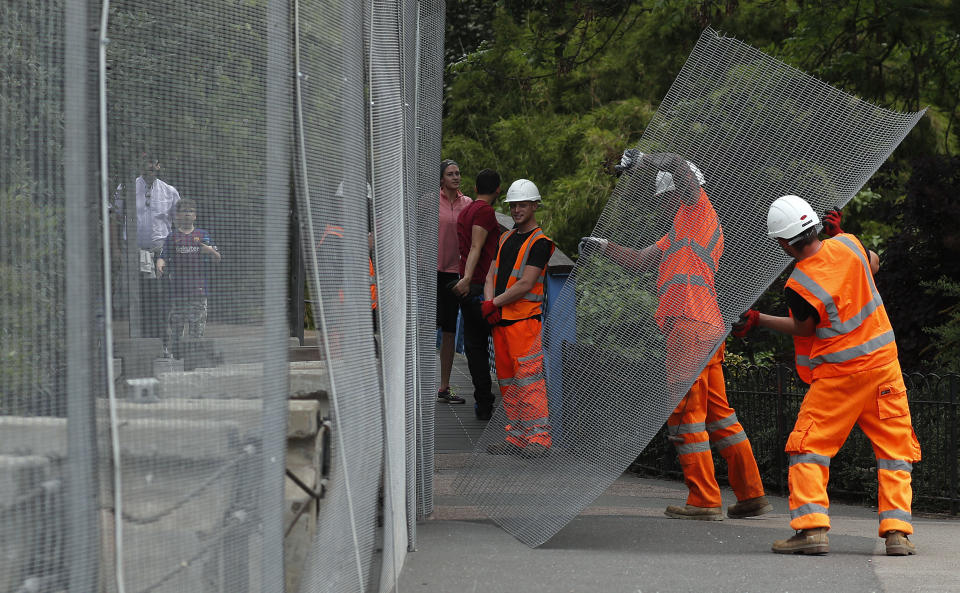 In this May 31, 2019, photo, workers build a fence around Winfield House, ahead of the State Visit by President Donald Trump, in London. Like a bull who keeps going back to the china shop, Trump is returning to Europe. (AP Photo/Frank Augstein)