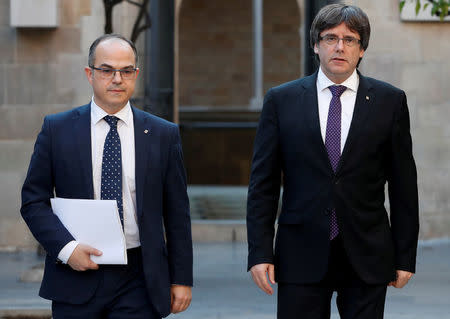 FILE PHOTO: Catalan President Carles Puigdemont (R) walks with Catalan Government Presidency Councillor Jordi Turull as they arrive to hold a cabinet meeting at the regional government headquarters, the Generalitat, in Barcelona, Spain October 17, 2017. REUTERS/Gonzalo Fuentes/File photo