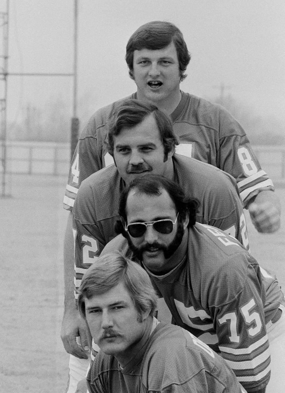 In this Jan. 7, 1974, photo, Dolphins defensive linemen, from top to bottom, Bill Stanfill, Bob Heinz, Manny Fernandez and Vern Den Herder pose in Houston during the Dolphins picture day for Super Bowl VIII. Stanfill, the former Georgia and Dolphins star, died at age 69. The university issued a statement on behalf of Stanfill’s family saying he died Thursday night, Nov. 10, 2016, in Albany, Ga.