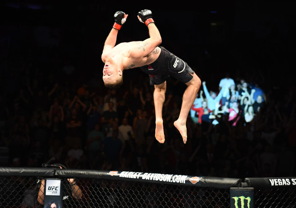 Justin Gaethje does a back flip off the cage Saturday in Lincoln, Neb., after knocking out James Vick with a crushing right hand in the first round of their bout at UFC Fight Night 135. (Getty Images)