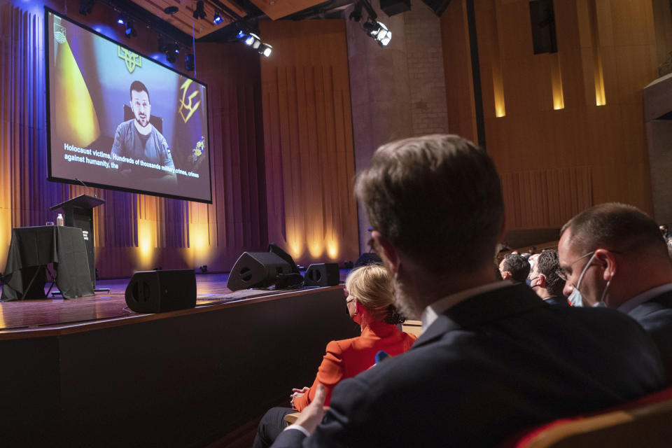 In this photo provided by the Australian National University Ukrainian President Volodymyr Zelenskyy appears on a screen during his online address to the university in Canberra, Australia, Wednesday, Aug. 3, 2022. Zelenskyy is addressing 21 Australian universities in an online discussion hosted by the Australian National University. (Tracey Nearmy/ANU via AP)