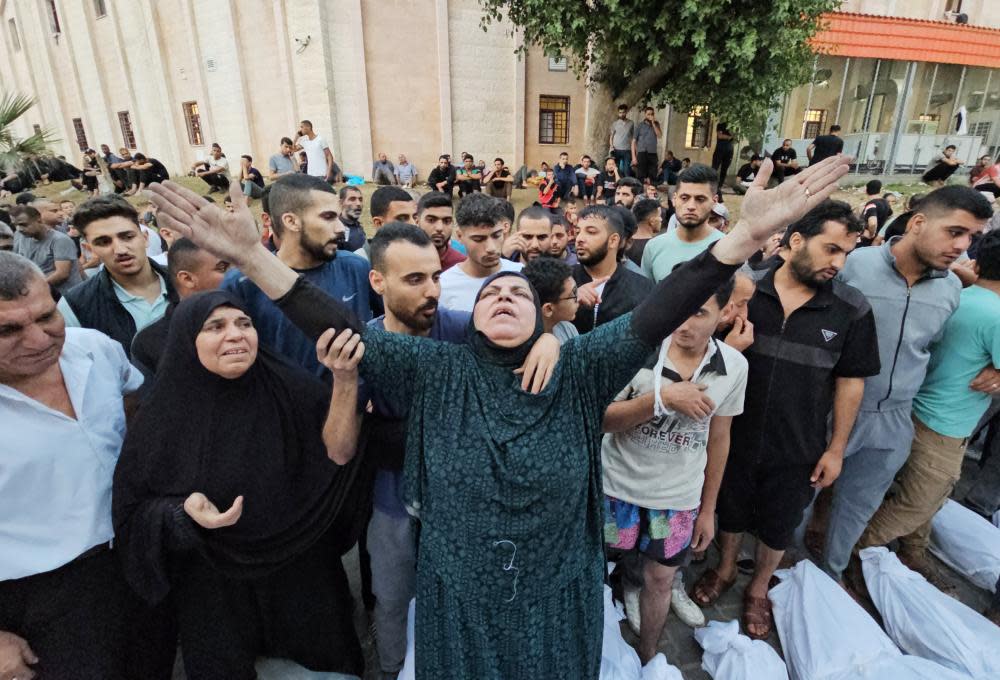 People mourn the dead at Jabaliah refugee camp.