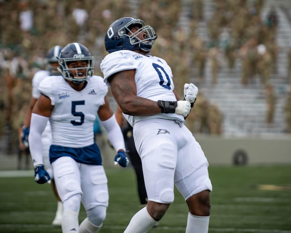 Georgia Southern senior defensive end Raymond Johnson III (0) celebrates a play with linebacker Benz Jose (5) against host Army on Nov. 21, 2020, in West Point, N.Y.
