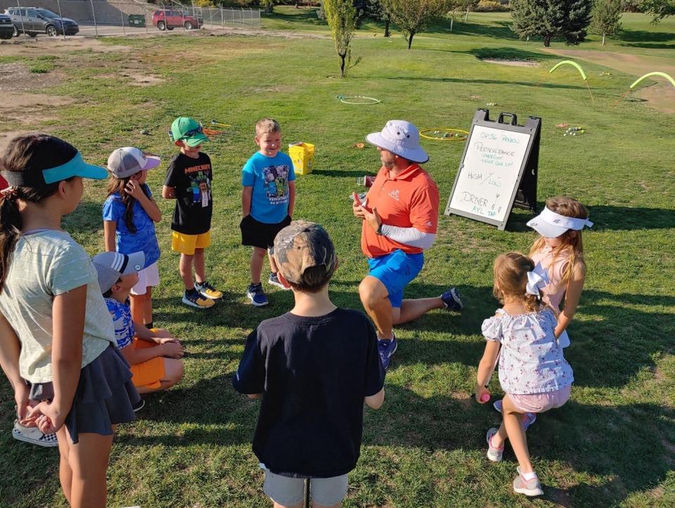 Participants in a First Tee - Four Corners program listen during a presentation at the Riverview Golf Course in Kirtland.