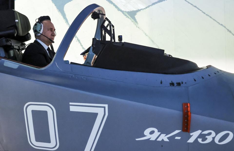 Russian President Vladimir Putin sits in a cockpit of a flight simulator at the Krasnodar Higher Military Aviation School of Pilots named after Anatoly Serov in Krasnodar, Russia, Thursday, March 7, 2024. (Mikhail Metzel, Sputnik, Kremlin Pool Photo via AP)