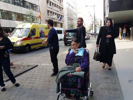 A woman is seen injured after clashes between supporters and opponents of the Turkish government outside the country's consulate in Brussels, in this handout picture released by Firat News Agency in Brussels, Belgium, March 30, 2017. Courtesy of Firat News Agency/Handout via REUTERS