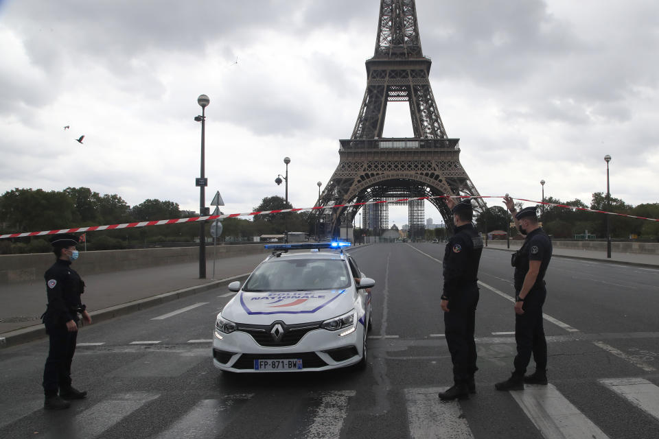 French police officers secure the bridge leading to the Eiffel Tower, Wednesday, Sept. 23, 2020 in Paris. Paris police have blockaded the area around the Eiffel Tower after a phone-in bomb threat. (AP Photo/Michel Euler)