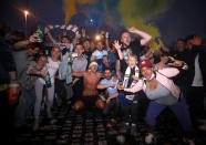 Leeds United fans celebrate outside Elland Road after Huddersfield Town beat West Bromwich Albion to seal their promotion to the Premier League.