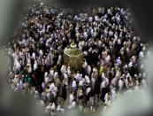 Muslim circle the Kaaba and pray in front of the station of Ibrahim "Maqam Ibrahim" during their Umrah Mawlid al-Nabawi pilgrimage, at the Grand Mosque in the holy city of Mecca January 13, 2014. Muslims mark Eid Mawlid al-Nabawi, or the birth of Prophet Mohammad on Tuesday. REUTERS/Amr Abdallah Dalsh (SAUDI ARABIA - Tags: RELIGION ANNIVERSARY)