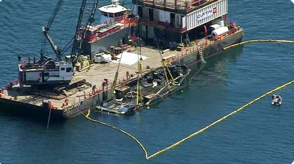 This photo from video provided by NBC/LA shows the burned hulk of the Conception being brought to the surface by a salvage team off Santa Cruz Island in the Santa Barbara Channel in Southern California Thursday, Sept. 12, 2019. The vessel burned and sank on Sept. 2, taking the lives of 34 people aboard. Five survived. (NBC/LA via AP)