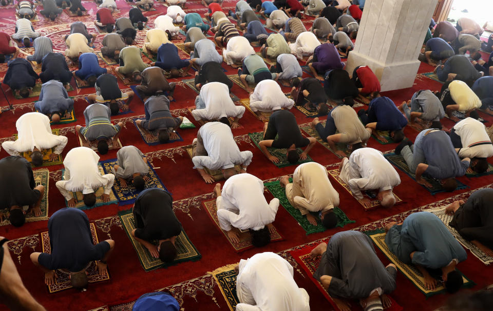 Palestinian worshippers wear protective face masks as they pray the last Friday prayer of the holy fasting month of Ramadan, to prevent the spread of coronavirus pandemic, at al-Hasaynih beach mosque in Gaza City, Friday, May 22, 2020. Palestinian worshippers are filling Gaza's mosques as they open for the central Friday prayers after nearly two months of closure due to the coronavirus threat. (AP Photo/Adel Hana)