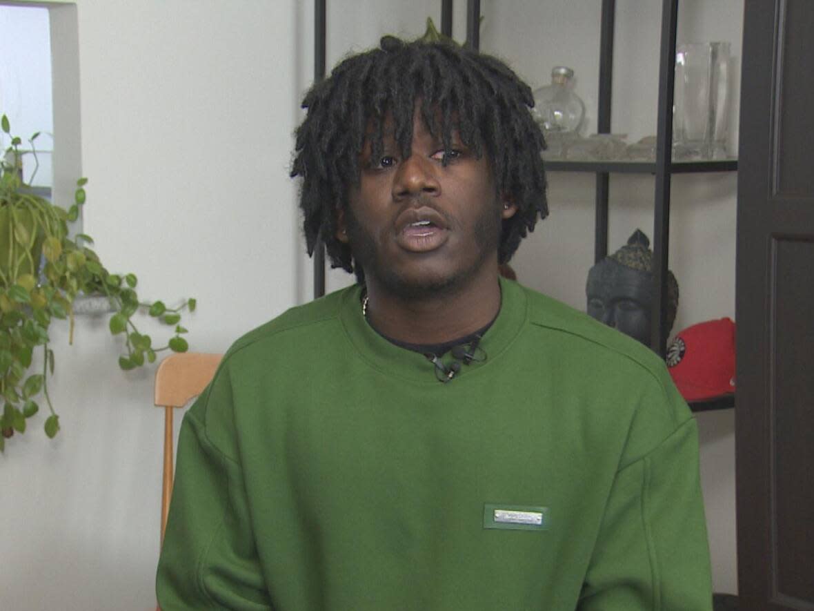 Ahmaud Benjamin Cockburn, 18, is suing the Toronto District School Board and the Toronto Police Services Board for negligence, alleging he was the victim and not the perpetrator of the fight. (Keith Burgess/CBC - image credit)