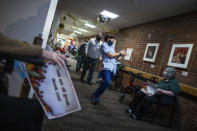 Nursing home residents hold signs as staff members walk by during a Thanksgiving celebration at the Hebrew Home at Riverdale, Thursday, Nov. 26, 2020, in New York. The home also offered drive-up visits for families of residents struggling with celebrating the holiday alone. (AP Photo/Eduardo Munoz Alvarez)