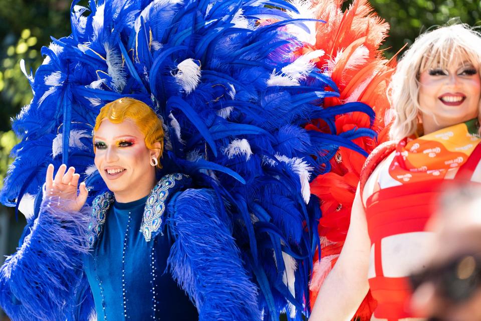 Drag queens from Palmas Tropical Escape bar wave to the crowds Saturday in Downtown Columbus.