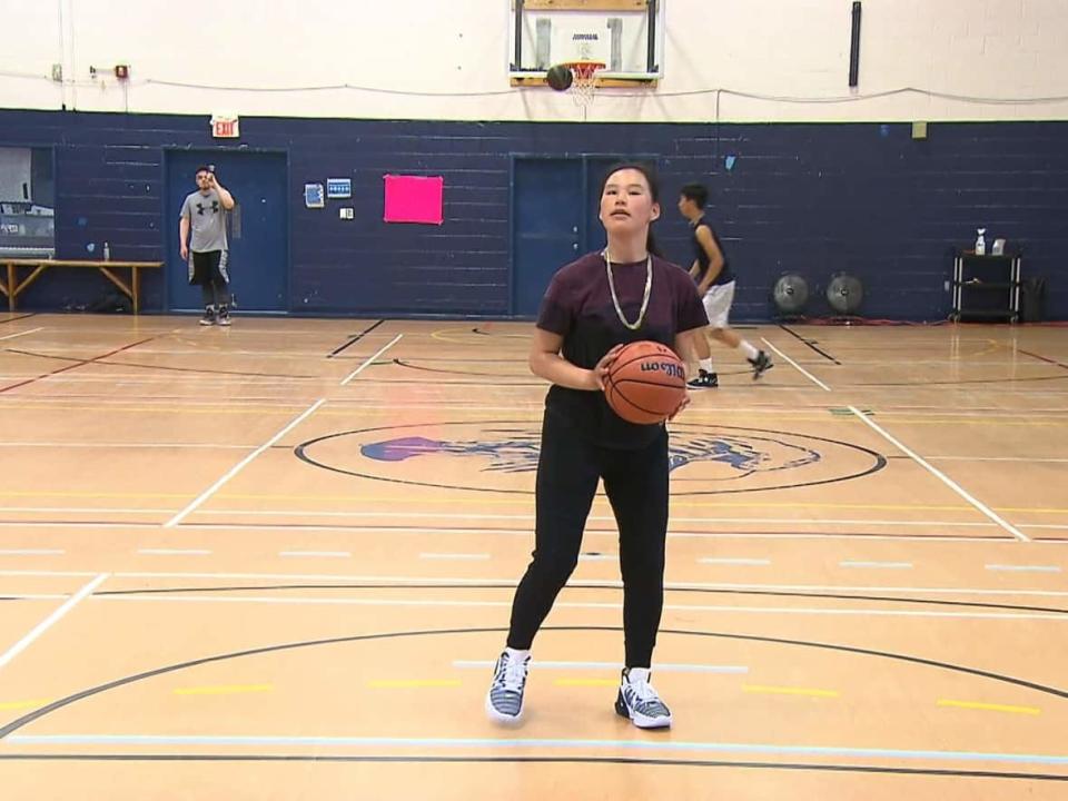 A girl takes a shot at the Kahnawake Youth Centre as a part of the Grind Now Shine Later Nunavik Basketball Camp.  (Khaled Yeddes/CBC - image credit)