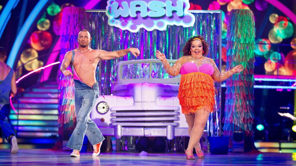 Robin Windsor and Lisa Riley jive in front of a car on the set of Strictly