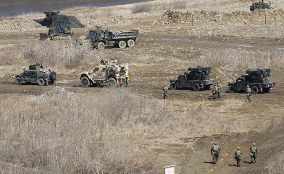 U.S. Army's soldiers pass by armored vehicles to cross the Hantan river at a training field in Yeoncheon, near the border with North Korea, Monday, March 13, 2023. The South Korean and U.S. militaries launched their biggest joint military exercises in years Monday, as North Korea said it conducted submarine-launched cruise missile tests in apparent protest of the drills it views as an invasion rehearsal. (AP Photo/Ahn Young-joon)
