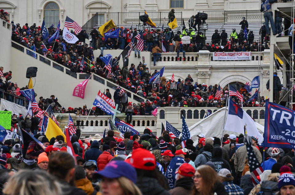 Protesters take over the Inaugural stage during a protest calling for legislators to overturn the election results in President Donald Trump's favor at the U.S. Capitol on Jan. 6, 2021 in Washington, D.C. / Credit: Ricky Carioti/The Washington Post via Getty Images